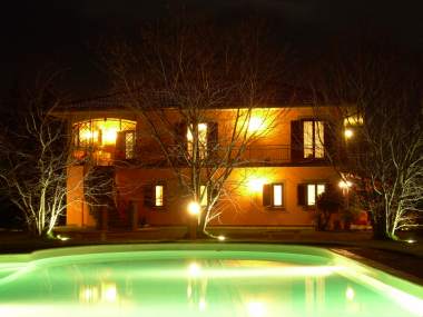 The swimming pool and the house by night